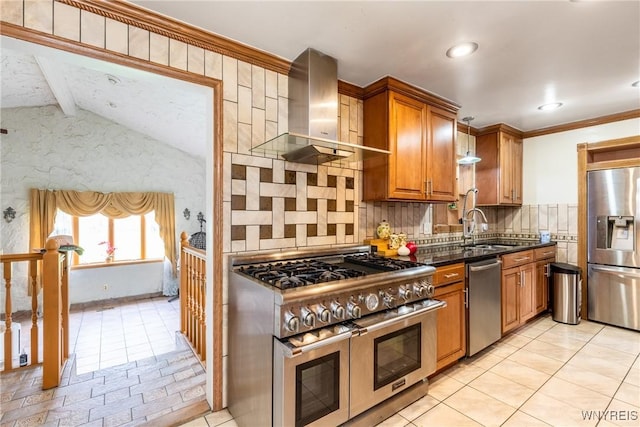 kitchen featuring decorative backsplash, wall chimney exhaust hood, brown cabinets, a sink, and stainless steel appliances