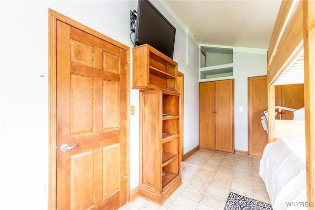 mudroom featuring baseboards and light tile patterned floors
