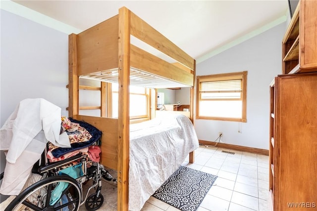 bedroom featuring light tile patterned flooring, baseboards, vaulted ceiling, and visible vents