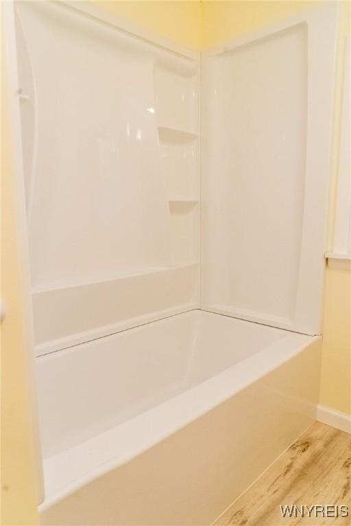 38 Carol Ave, Pomfret, NY 14063 - full bathroom with wood finished floors, baseboards, and tub / shower combination