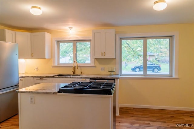 38 Carol Ave, Pomfret, NY 14063 - kitchen featuring freestanding refrigerator, a sink, light wood finished floors, a center island, and white cabinetry