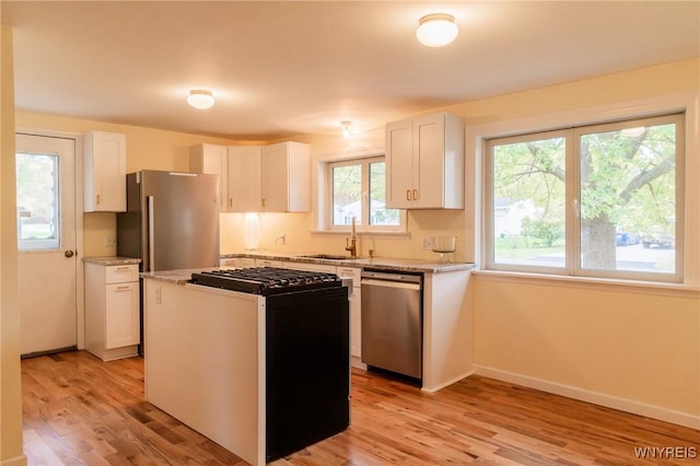 38 Carol Ave, Pomfret, NY 14063 - kitchen with stainless steel appliances, a sink, white cabinetry, and light wood-type flooring