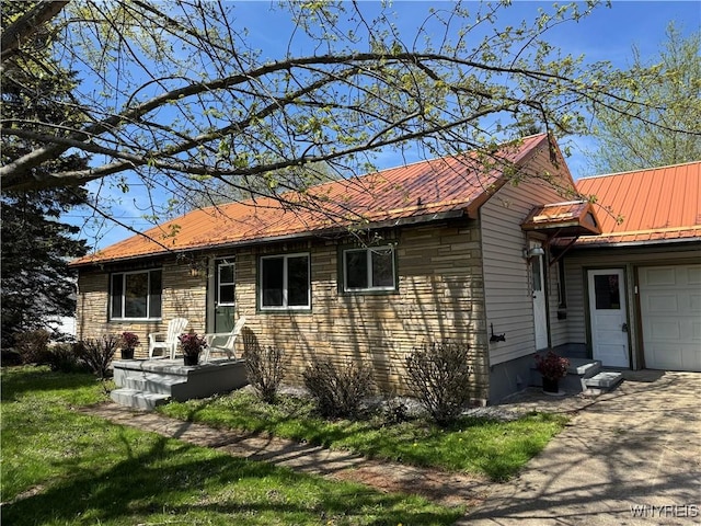 38 Carol Ave, Pomfret, NY 14063 - view of front of home with driveway, metal roof, a garage, and stone siding