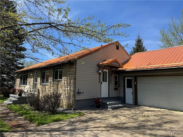 38 Carol Ave, Pomfret, NY 14063 - view of front of home with an attached garage, metal roof, and driveway