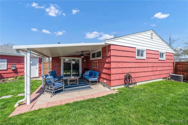rear view of property featuring ceiling fan, outdoor lounge area, cooling unit, a patio, and a yard