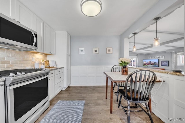kitchen with white cabinetry, appliances with stainless steel finishes, and a healthy amount of sunlight