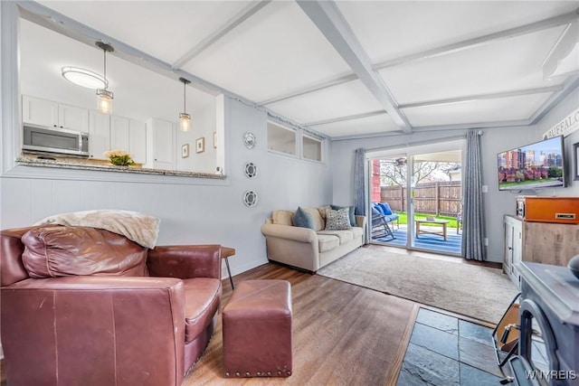 living room featuring baseboards, wood finished floors, beam ceiling, and coffered ceiling
