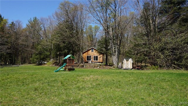 11 Lake Pennock Dr, Orwell, NY 13144 - view of green lawn with a playground, a storage shed, and an outbuilding
