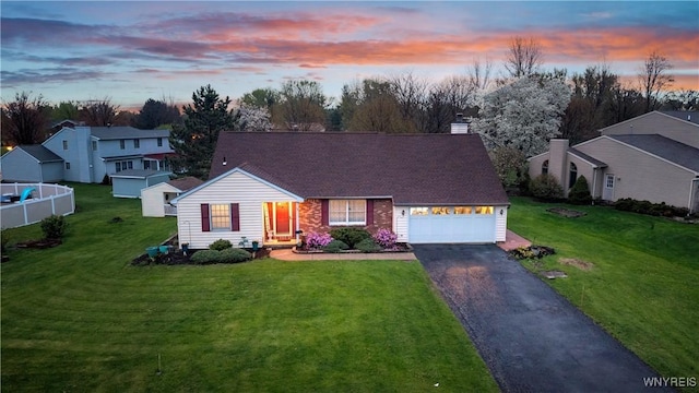 view of front of property with an attached garage, a residential view, a front yard, and aphalt driveway