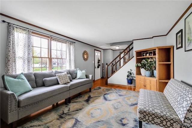 living area featuring stairway, baseboards, ornamental molding, and wood finished floors