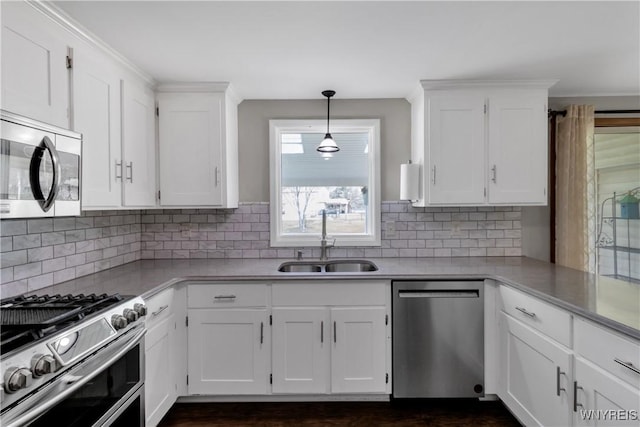 kitchen with light countertops, a sink, white cabinets, and stainless steel appliances