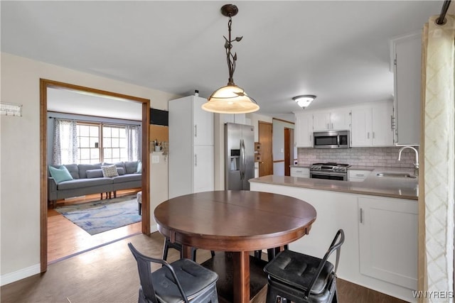 dining room with baseboards and wood finished floors