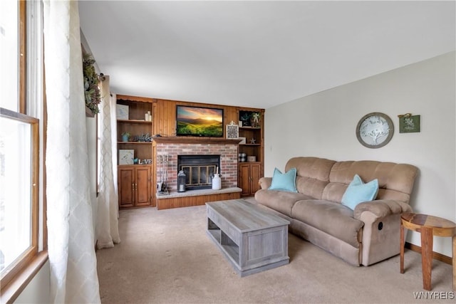 living area featuring light colored carpet, built in features, and a fireplace