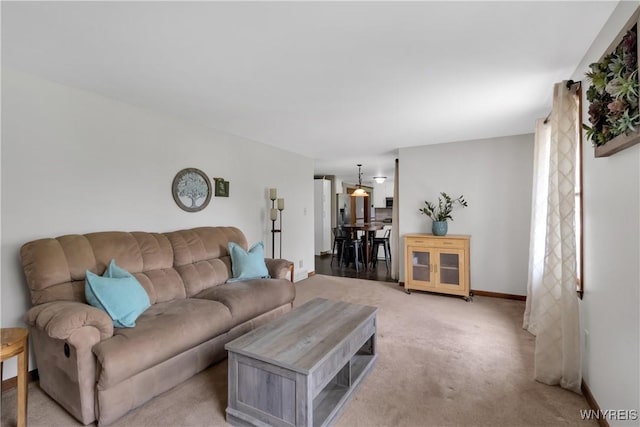 living room featuring baseboards and light carpet