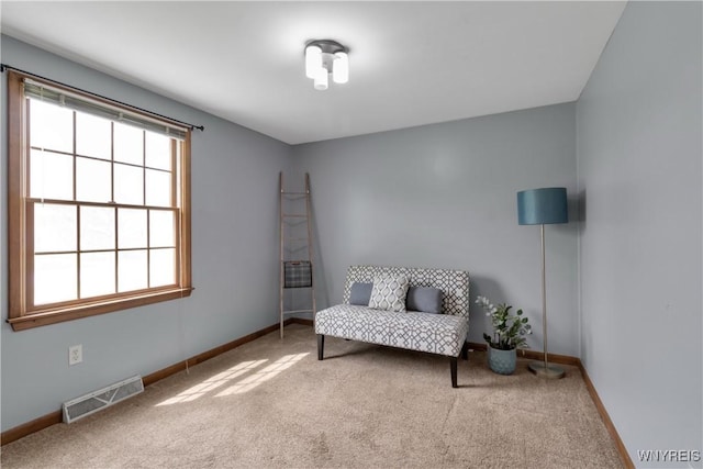 sitting room featuring carpet floors, baseboards, and visible vents