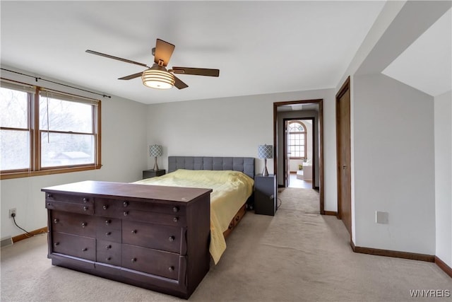 bedroom featuring baseboards, ceiling fan, and light carpet