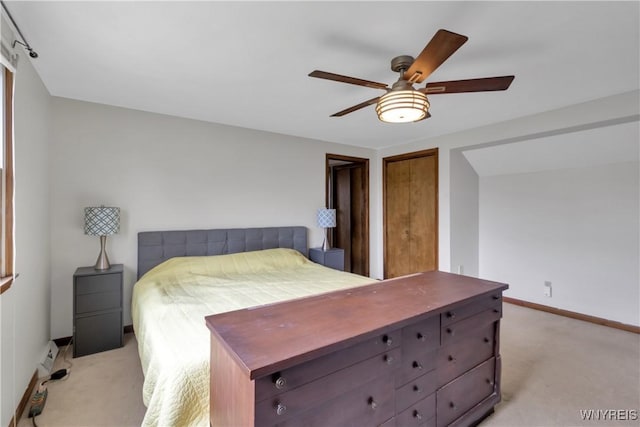 bedroom featuring a ceiling fan, baseboards, and light carpet