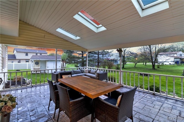 view of patio / terrace with an outbuilding, outdoor dining area, and a shed