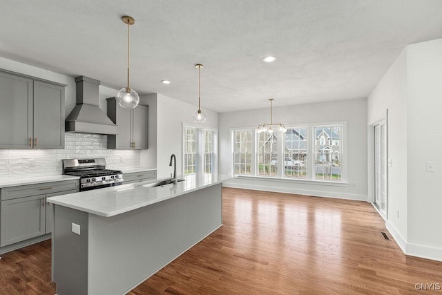 LOT379TIMBERBANKS 8032 Forest Rdg, Lysander, NY 13027 - kitchen featuring wall chimney range hood, stainless steel gas range, gray cabinetry, and a wealth of natural light