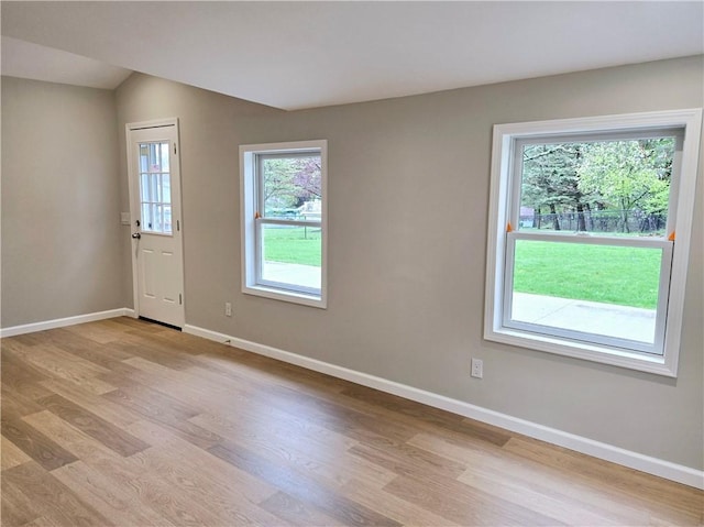 entryway with baseboards and light wood-style floors