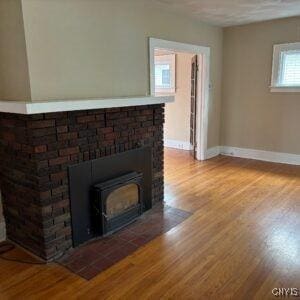 118 Ruhamah Ave, Onondaga, NY 13205 - room details with a fireplace with flush hearth, baseboards, and wood finished floors