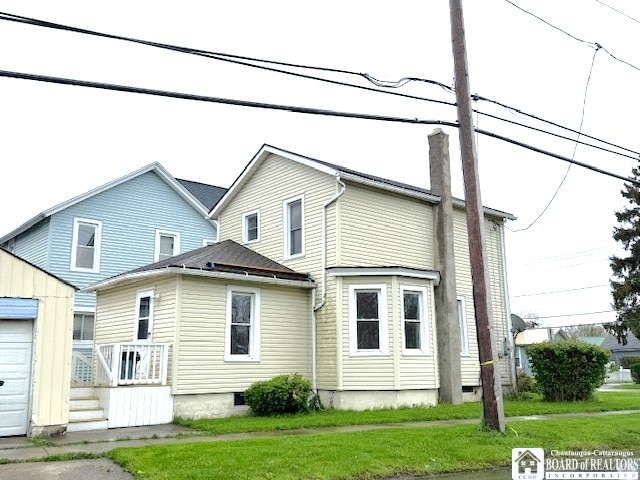 184 W 2nd St, Dunkirk-City, NY 14048 - rear view of property featuring an outdoor structure, crawl space, a yard, and a chimney