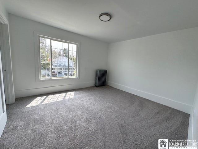 184 W 2nd St, Dunkirk-City, NY 14048 - unfurnished room featuring baseboards, carpet, and radiator