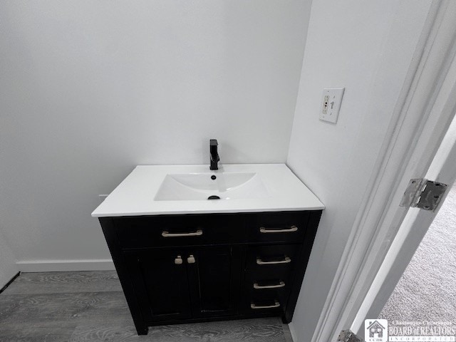 184 W 2nd St, Dunkirk-City, NY 14048 - bathroom featuring vanity, baseboards, and wood finished floors