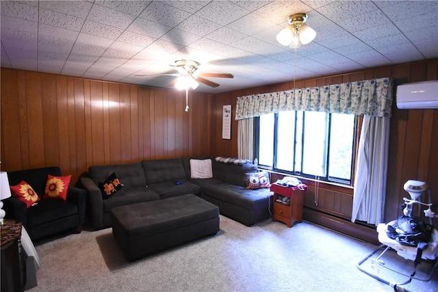 carpeted living area featuring an AC wall unit, a ceiling fan, and wooden walls
