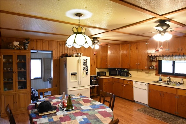 kitchen with a sink, light countertops, ceiling fan, and white appliances