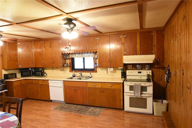 kitchen with a sink, white appliances, under cabinet range hood, brown cabinets, and a ceiling fan