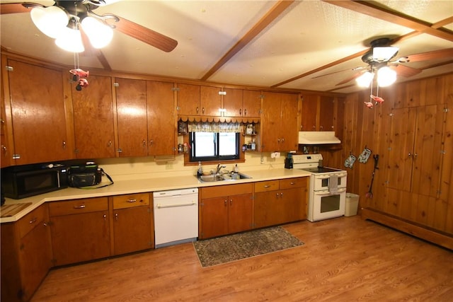 kitchen with a sink, white appliances, under cabinet range hood, brown cabinets, and a ceiling fan