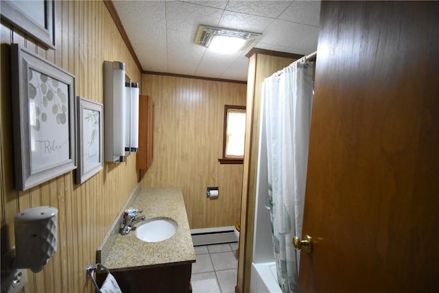 bathroom featuring vanity, wood walls, a baseboard heating unit, and tile patterned floors
