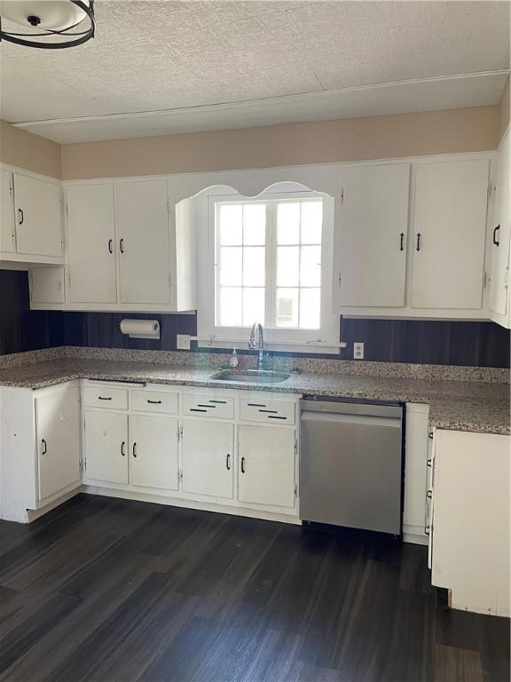 kitchen featuring a sink, dishwasher, and white cabinets