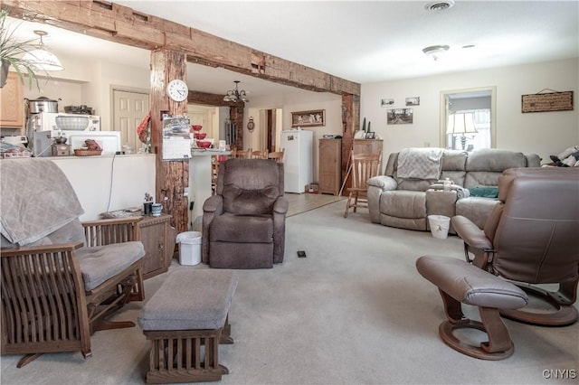 living room with water heater and light colored carpet