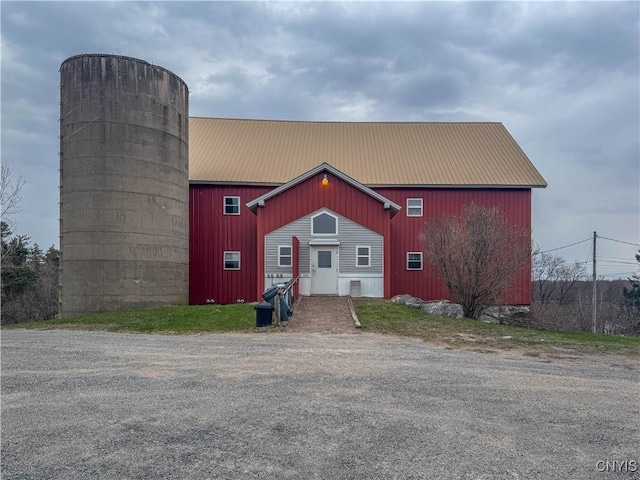exterior space with an outbuilding and metal roof
