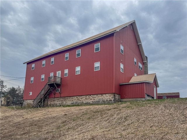 view of side of property featuring stairway