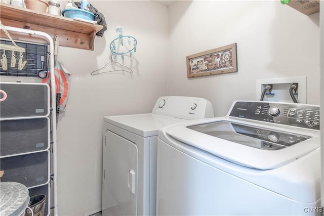 clothes washing area with separate washer and dryer and laundry area