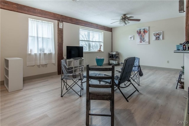dining area featuring a ceiling fan, baseboards, and light wood-style floors