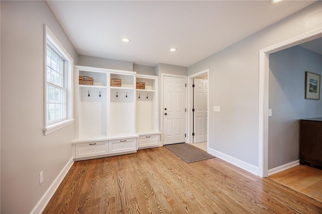 mudroom with recessed lighting, baseboards, and light wood-style floors