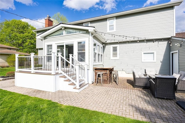 back of property with a patio area and a chimney