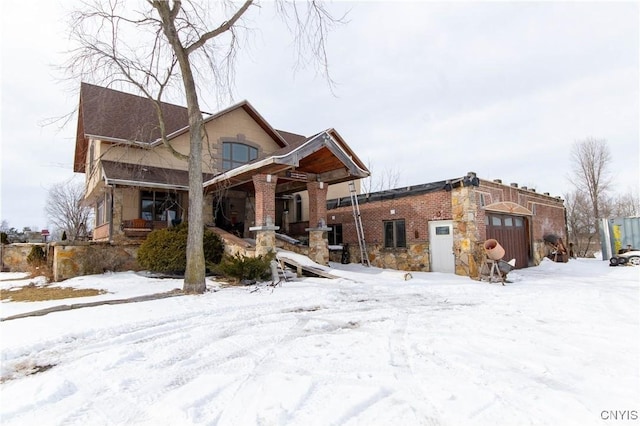 view of front of property featuring a porch and stone siding