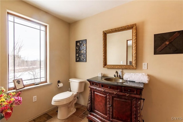 half bathroom featuring toilet and vanity