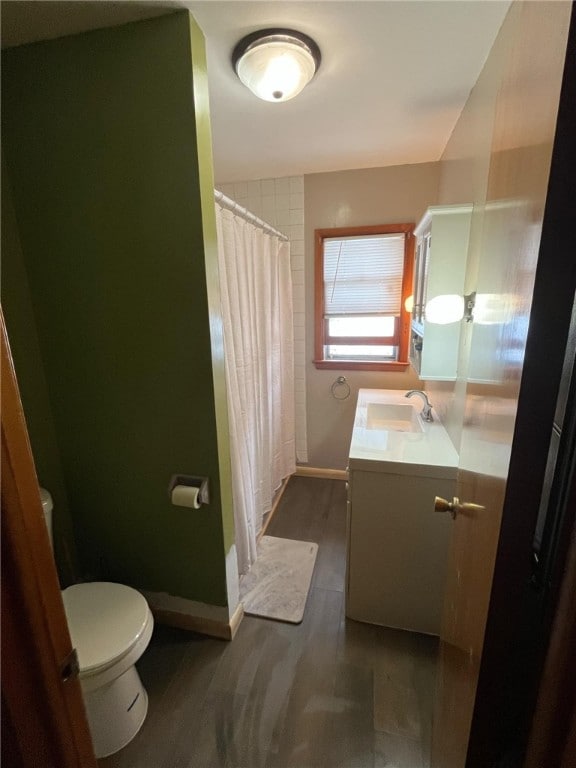 2 Park Pl, Delhi, NY 13753 - bathroom with vanity, toilet, a shower with shower curtain, baseboards, and wood finished floors