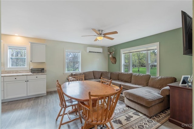 216 Harry Bryant Rd, Amboy, NY 13493 - dining space featuring an AC wall unit, plenty of natural light, light wood-style flooring, and ceiling fan