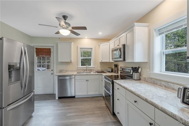 216 Harry Bryant Rd, Amboy, NY 13493 - kitchen with appliances with stainless steel finishes, a sink, healthy amount of natural light, white cabinets, and recessed lighting