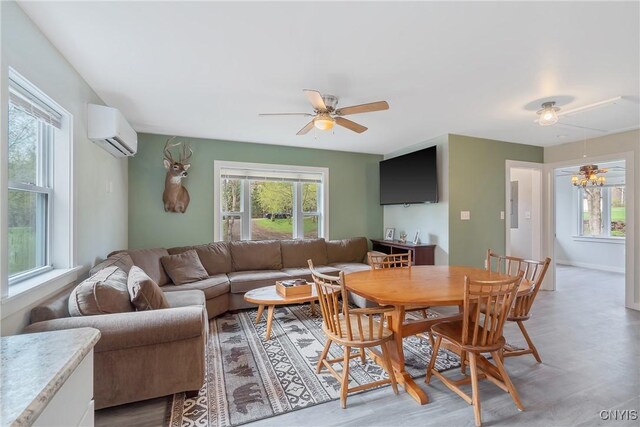 216 Harry Bryant Rd, Amboy, NY 13493 - living area featuring a wall mounted air conditioner, plenty of natural light, ceiling fan, and light wood-style flooring