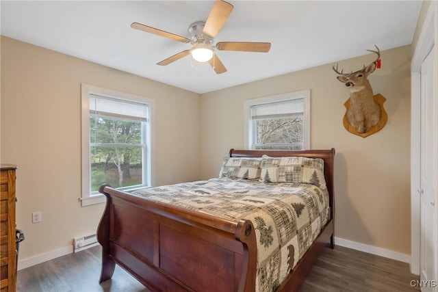 216 Harry Bryant Rd, Amboy, NY 13493 - bedroom with a baseboard heating unit, baseboards, dark wood-style flooring, and a ceiling fan