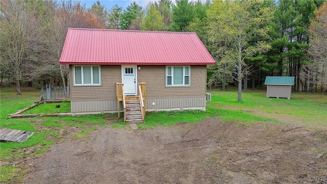 216 Harry Bryant Rd, Amboy, NY 13493 - view of front of home with metal roof and a front lawn