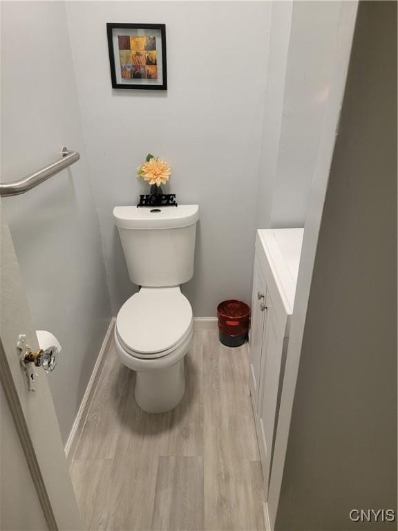 201 E Kennedy St, Syracuse, NY 13205 - half bathroom featuring vanity, baseboards, wood finished floors, and toilet